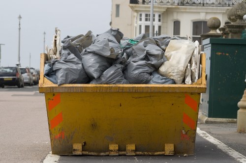 Workers loading bags and furniture into a van on a residential street in Mayfair